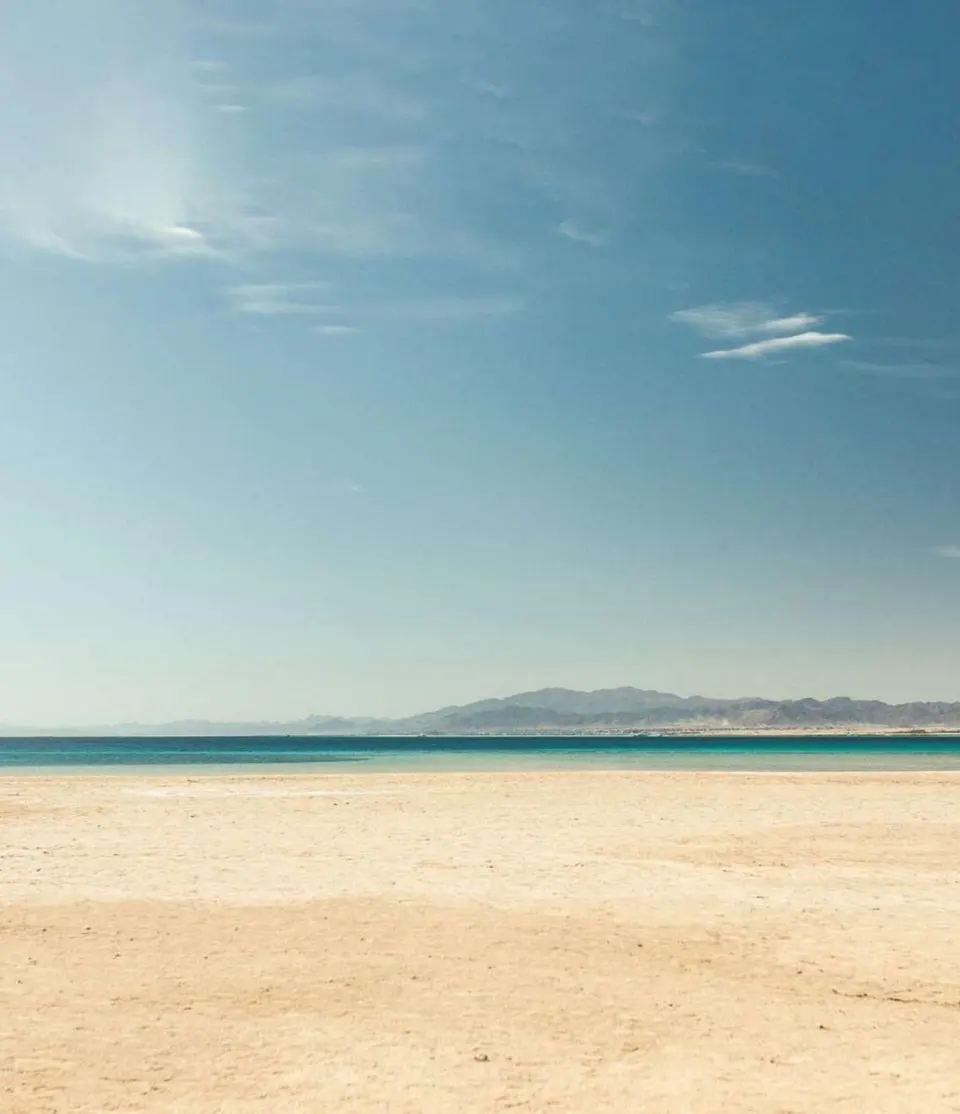 A broad sandy beach and clear Red Sea water in Somabay