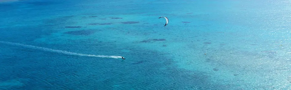 Kitesurfer crossing the clear water of Somabay’s kite lagoon