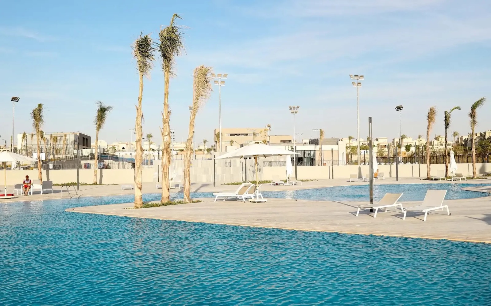 Villette, New Cairo — the swimming pool and club terrace, with the compound behind