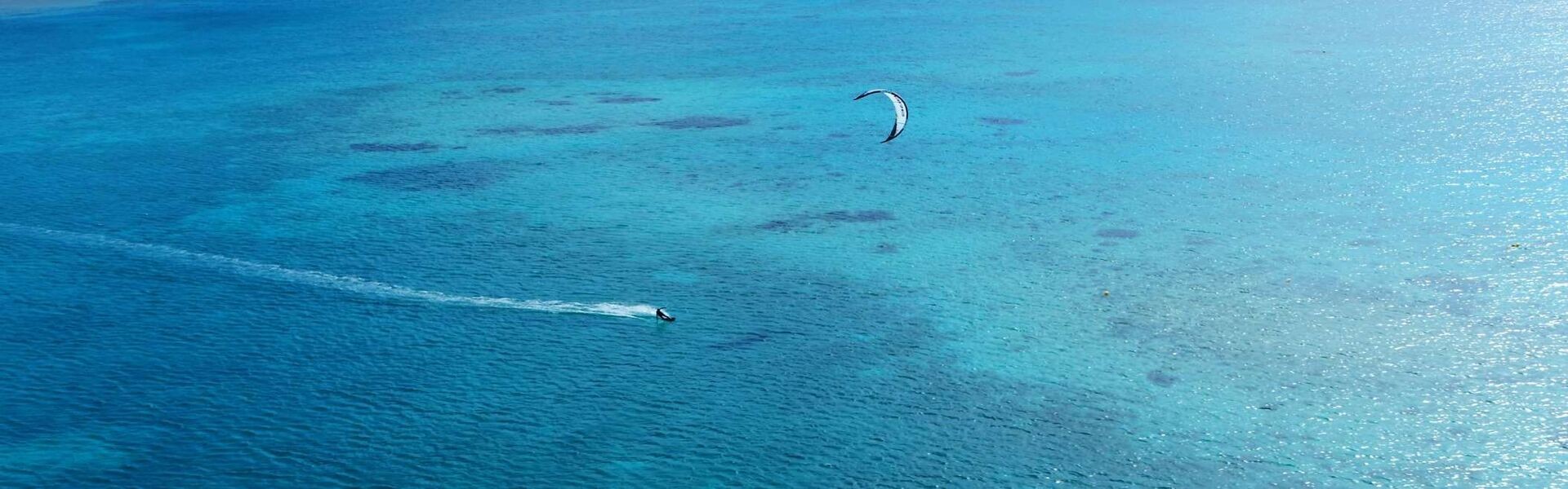 Kite-surfing on the turquoise lagoon off Somabay